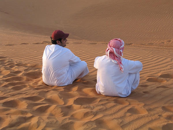 朋友们坐在中东的沙滩上